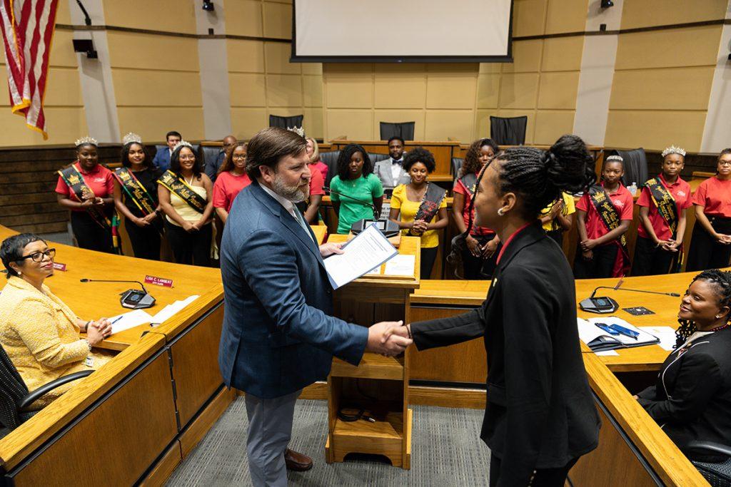 Mayor Spiro Cheriogotis presenting the City of Mobile proclamation during the Miss Juneteenth America fifth-anniversary recognition.