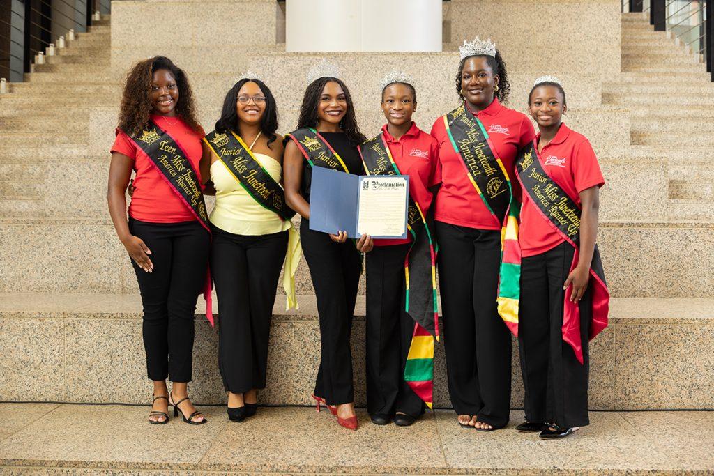 Miss Juneteenth America representatives holding the City of Mobile fifth-anniversary proclamation during the June 23, 2026 recognition.