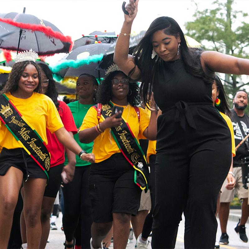 Shamonee Baker participating with Miss Juneteenth America representatives during the Second Line Parade.