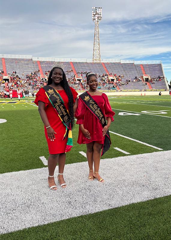 Queen Erin Hammond and Cayliegh Humphrey representing Miss Juneteenth America on the field at the 2026 Port City Classic.