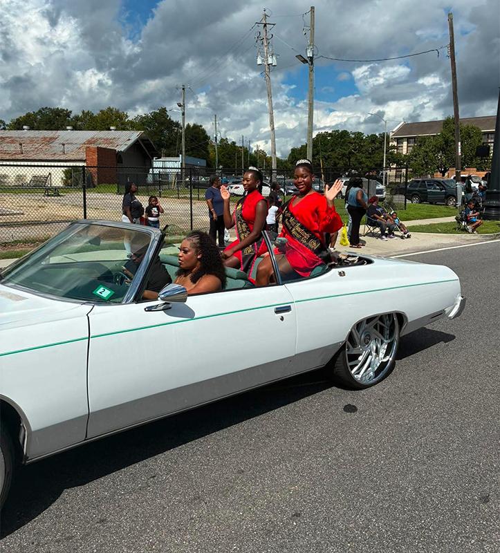 Miss Juneteenth America representatives waving to the crowd during the 2026 Port City Classic parade in Mobile, Alabama